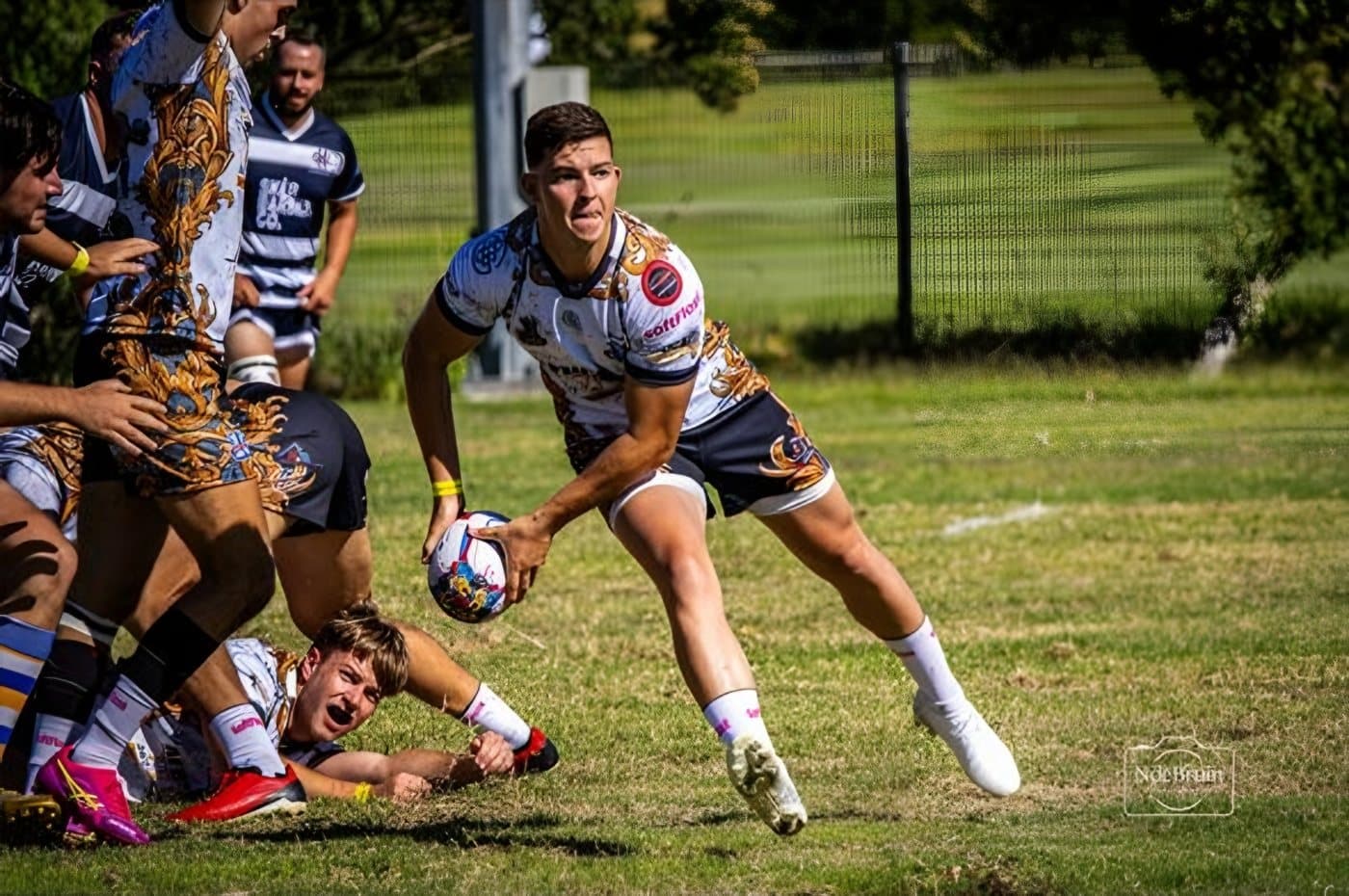 A Raptors scrumhalf passing off the base of a ruck in the 2026 kit